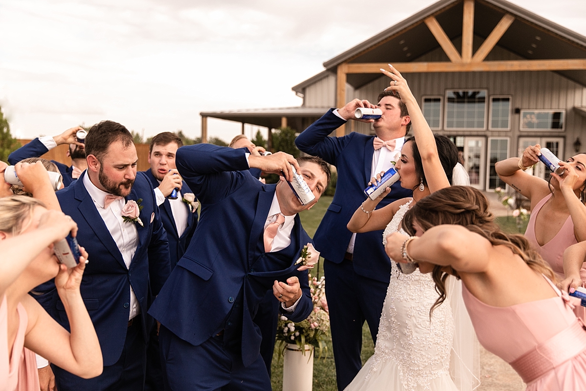 fun bridal party shotgunning a beer